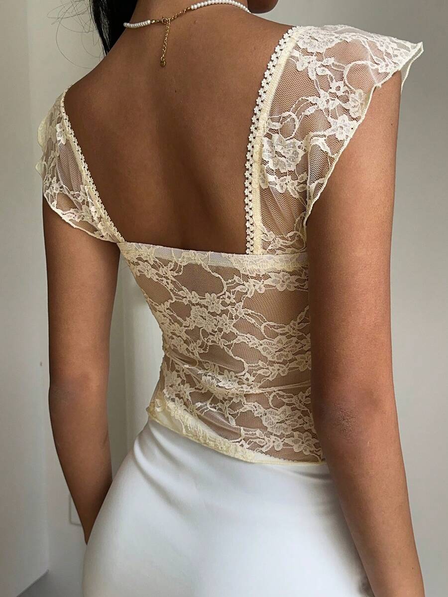 Flirty lace top with ruffles, sweetheart neckline and short sleeves