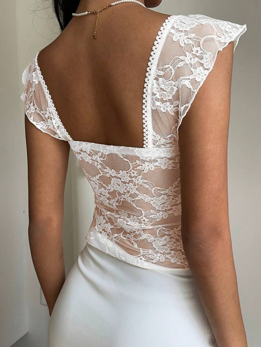 Flirty lace top with ruffles, sweetheart neckline and short sleeves
