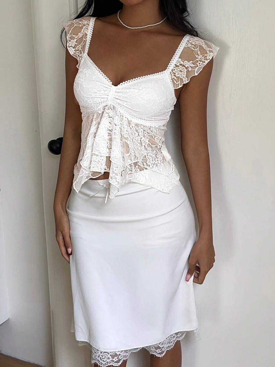 Flirty lace top with ruffles, sweetheart neckline and short sleeves