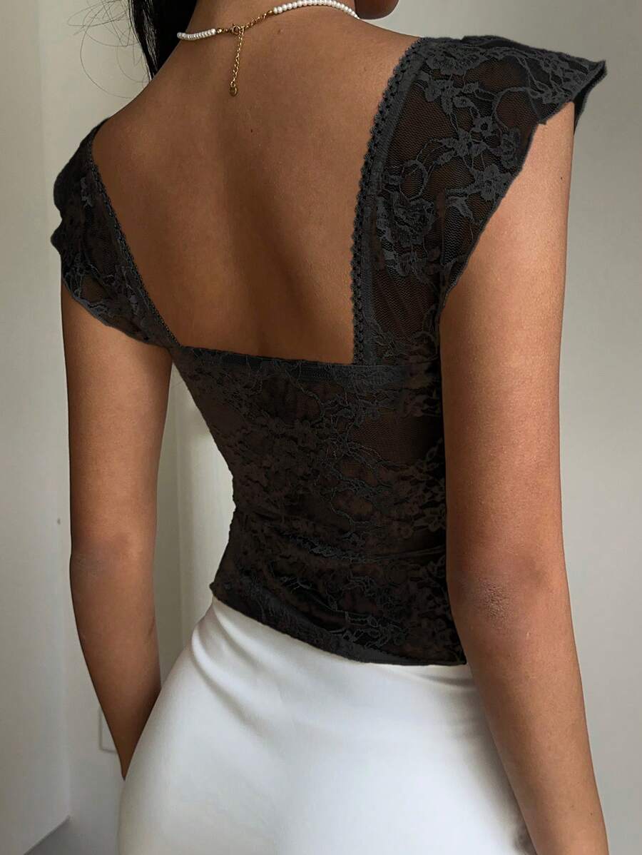 Flirty lace top with ruffles, sweetheart neckline and short sleeves