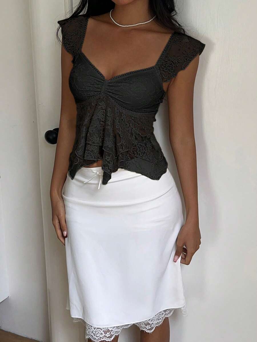 Flirty lace top with ruffles, sweetheart neckline and short sleeves