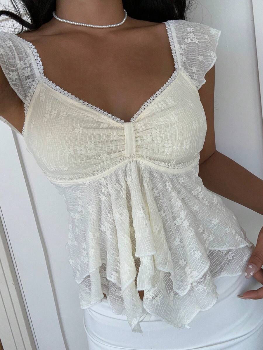 Flirty lace top with ruffles, sweetheart neckline and short sleeves