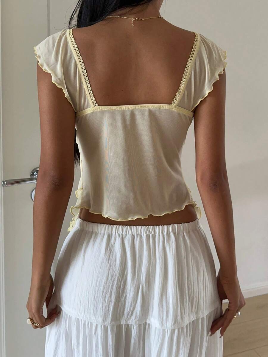Flirty lace top with ruffles, sweetheart neckline and short sleeves