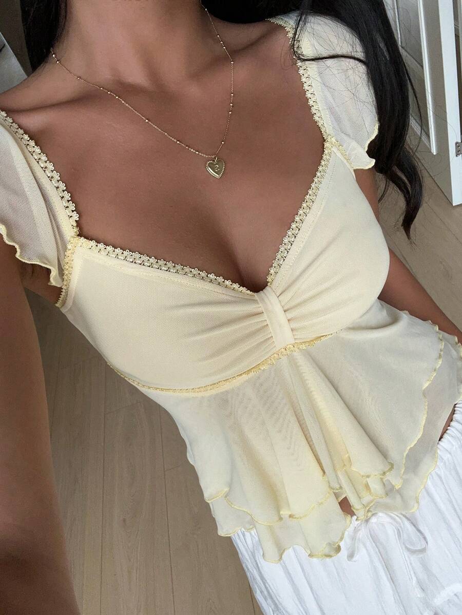 Flirty lace top with ruffles, sweetheart neckline and short sleeves