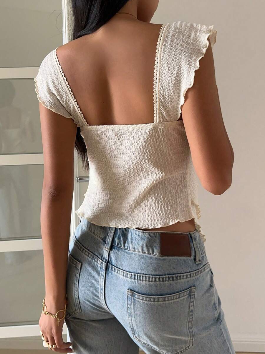 Flirty lace top with ruffles, sweetheart neckline and short sleeves