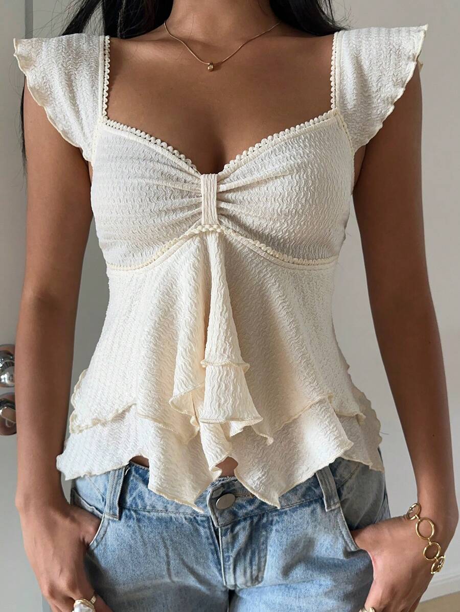 Flirty lace top with ruffles, sweetheart neckline and short sleeves