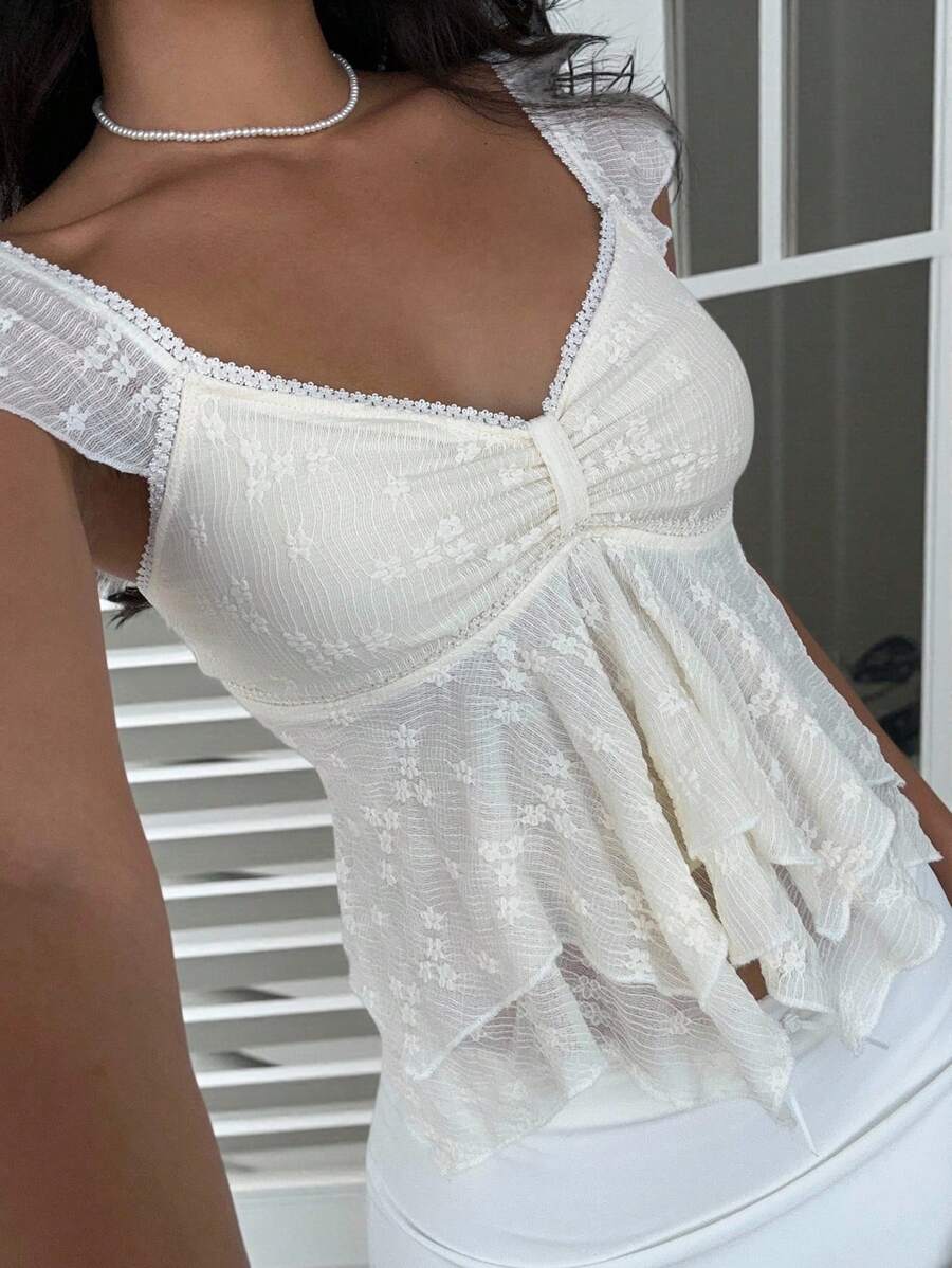 Flirty lace top with ruffles, sweetheart neckline and short sleeves