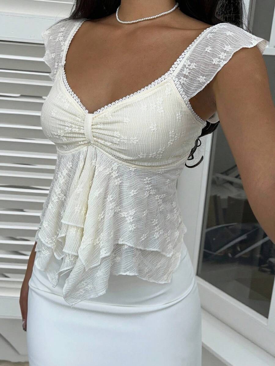 Flirty lace top with ruffles, sweetheart neckline and short sleeves