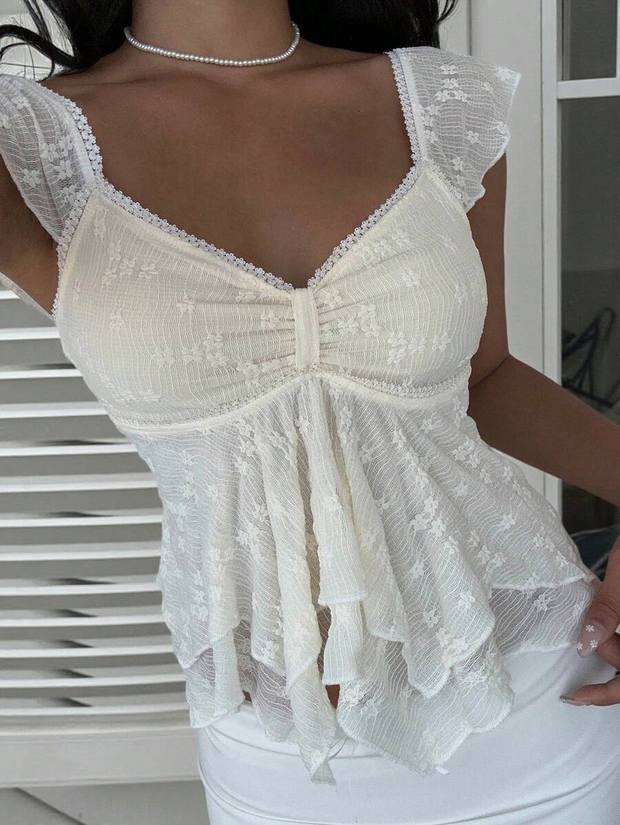 Flirty lace top with ruffles, sweetheart neckline and short sleeves