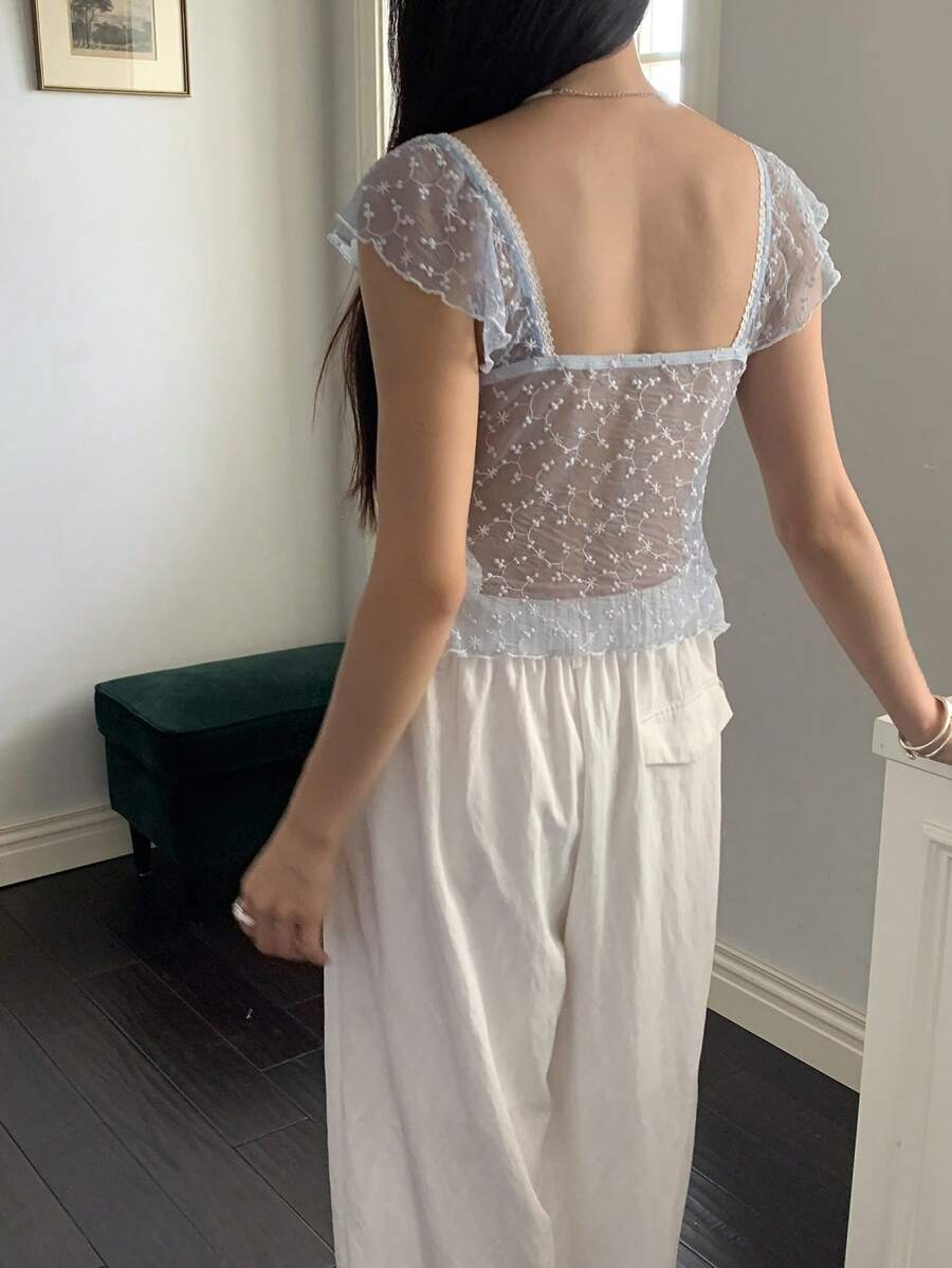Flirty lace top with ruffles, sweetheart neckline and short sleeves
