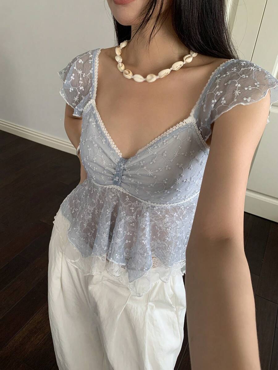 Flirty lace top with ruffles, sweetheart neckline and short sleeves