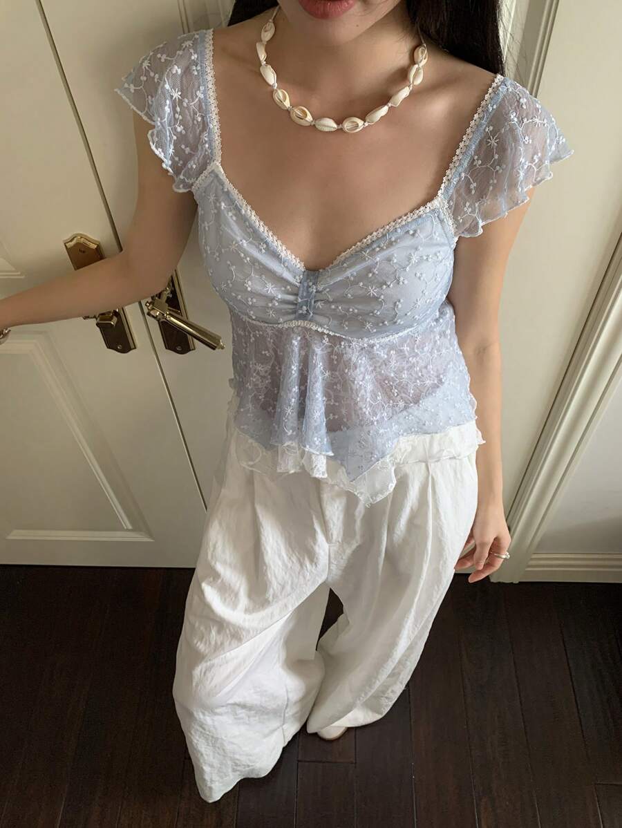 Flirty lace top with ruffles, sweetheart neckline and short sleeves