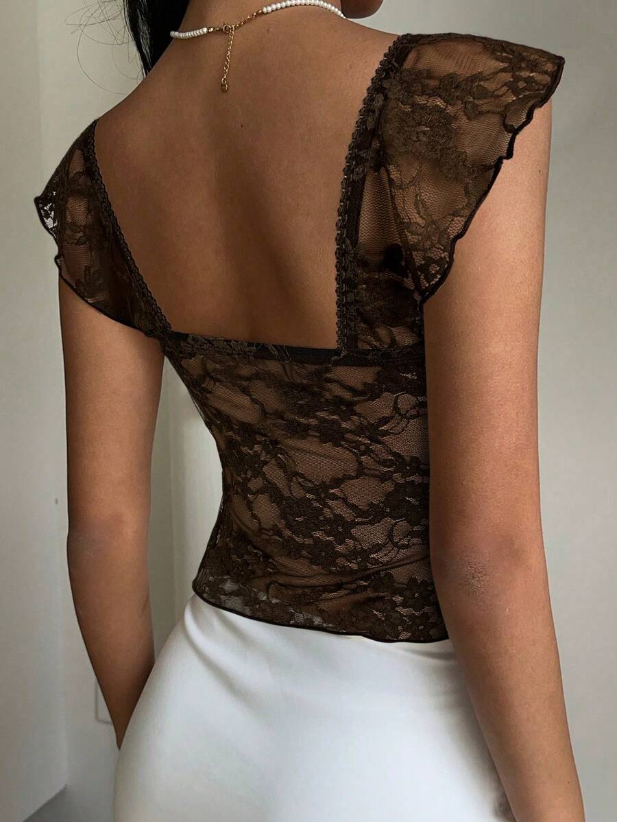 Flirty lace top with ruffles, sweetheart neckline and short sleeves