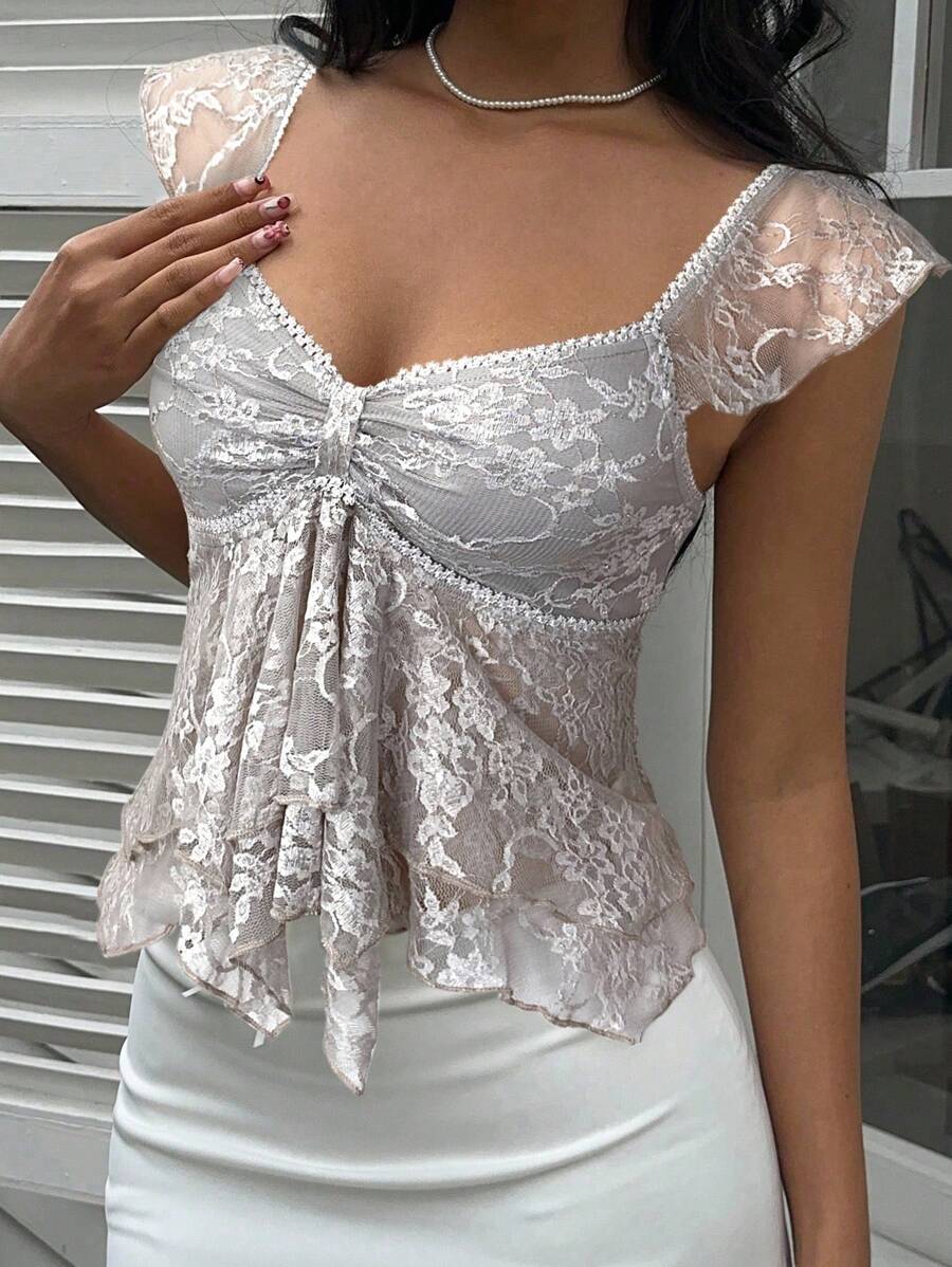 Flirty lace top with ruffles, sweetheart neckline and short sleeves