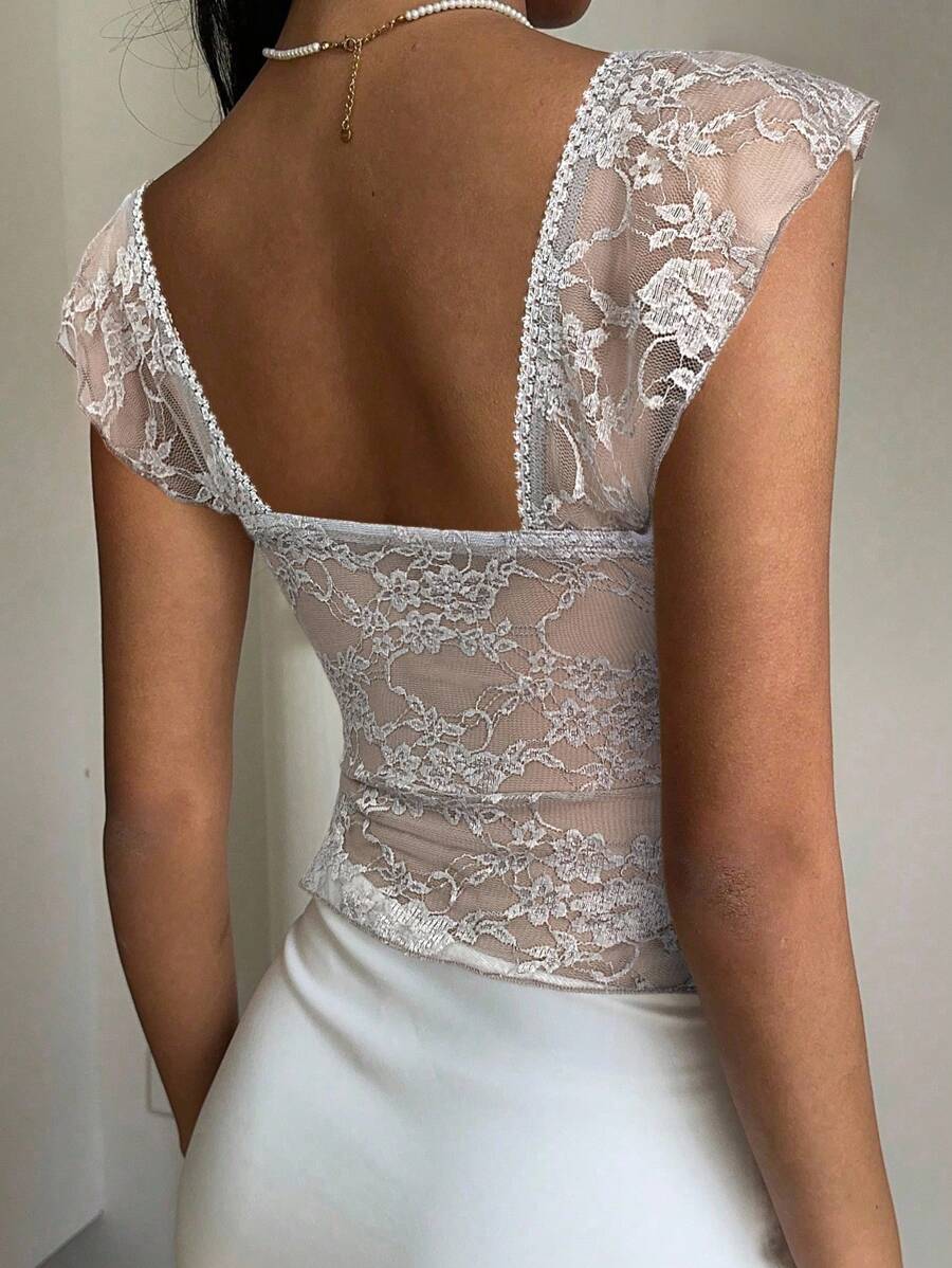 Flirty lace top with ruffles, sweetheart neckline and short sleeves